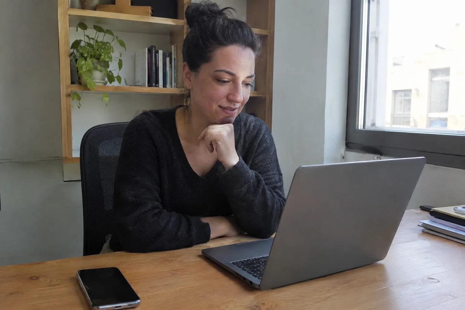 A business owner checks how long it takes to produce an AI video on his laptop.